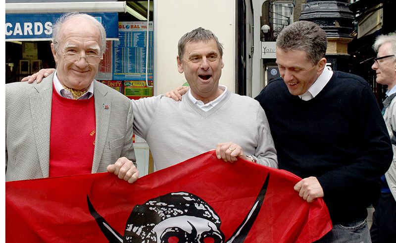 Alan, Tony and Grant Benson, with George Saunders passing by. Alan has managed to match his Jolly Roger to his sweater.