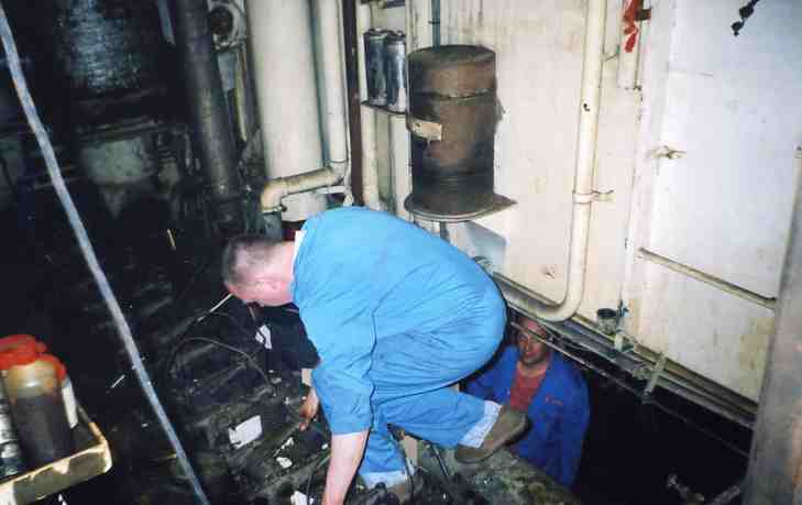 Paul working as Spike looks on