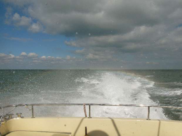 Rainbow over stern of Spartacus